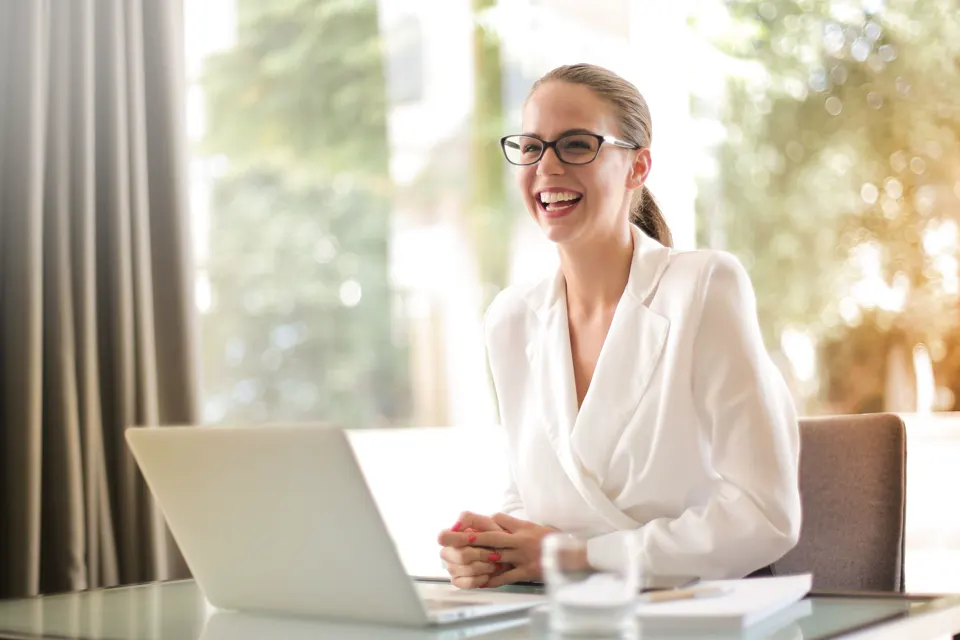 A professional adult in an office looking toward the camera.