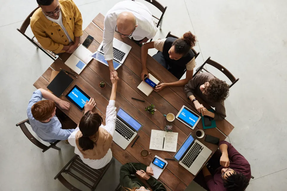 Adults talking across a meeting table.