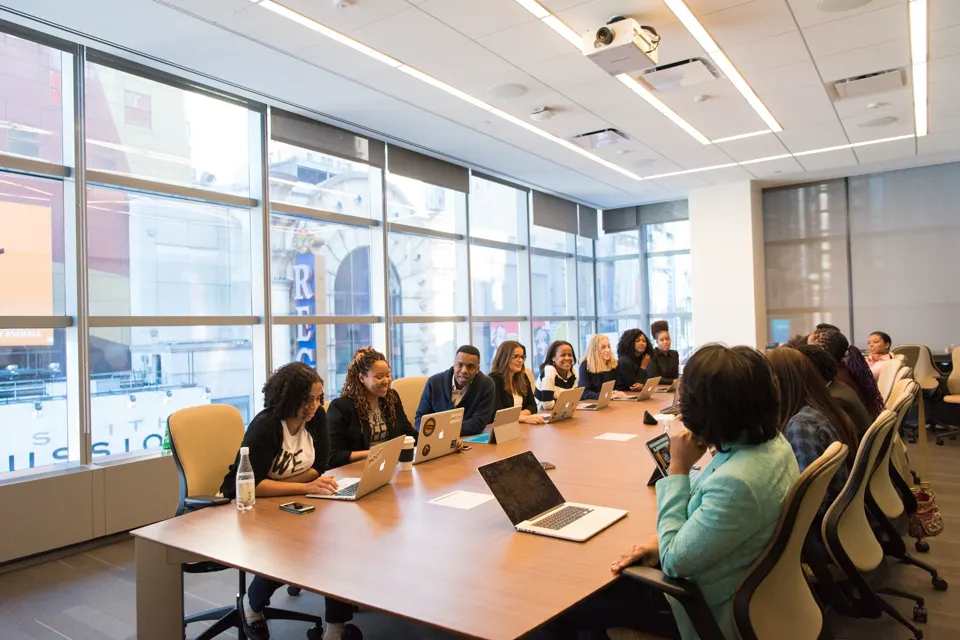 People in a conference room listening to a presentation.